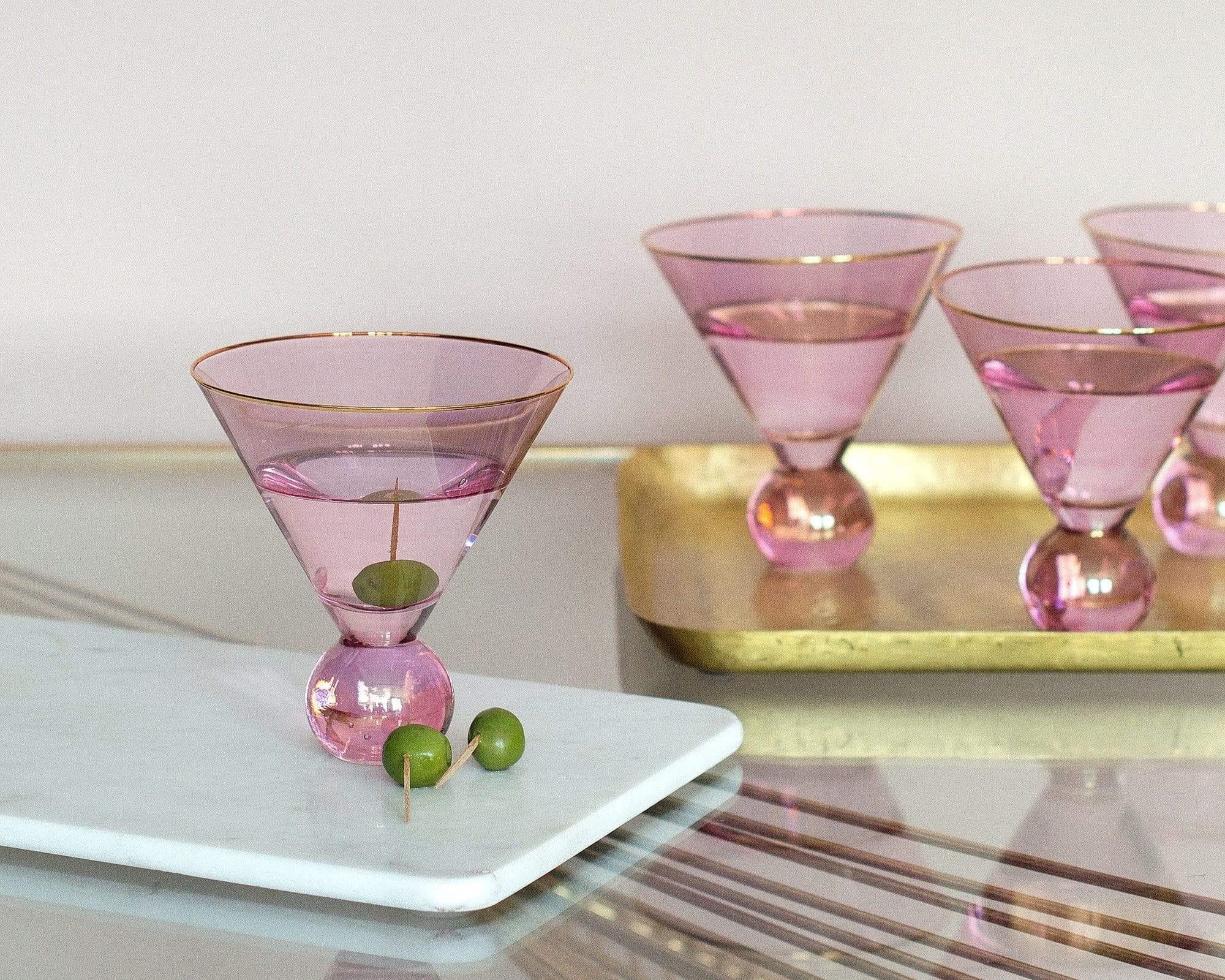 Pink martini glasses with gold rims and a gold tray