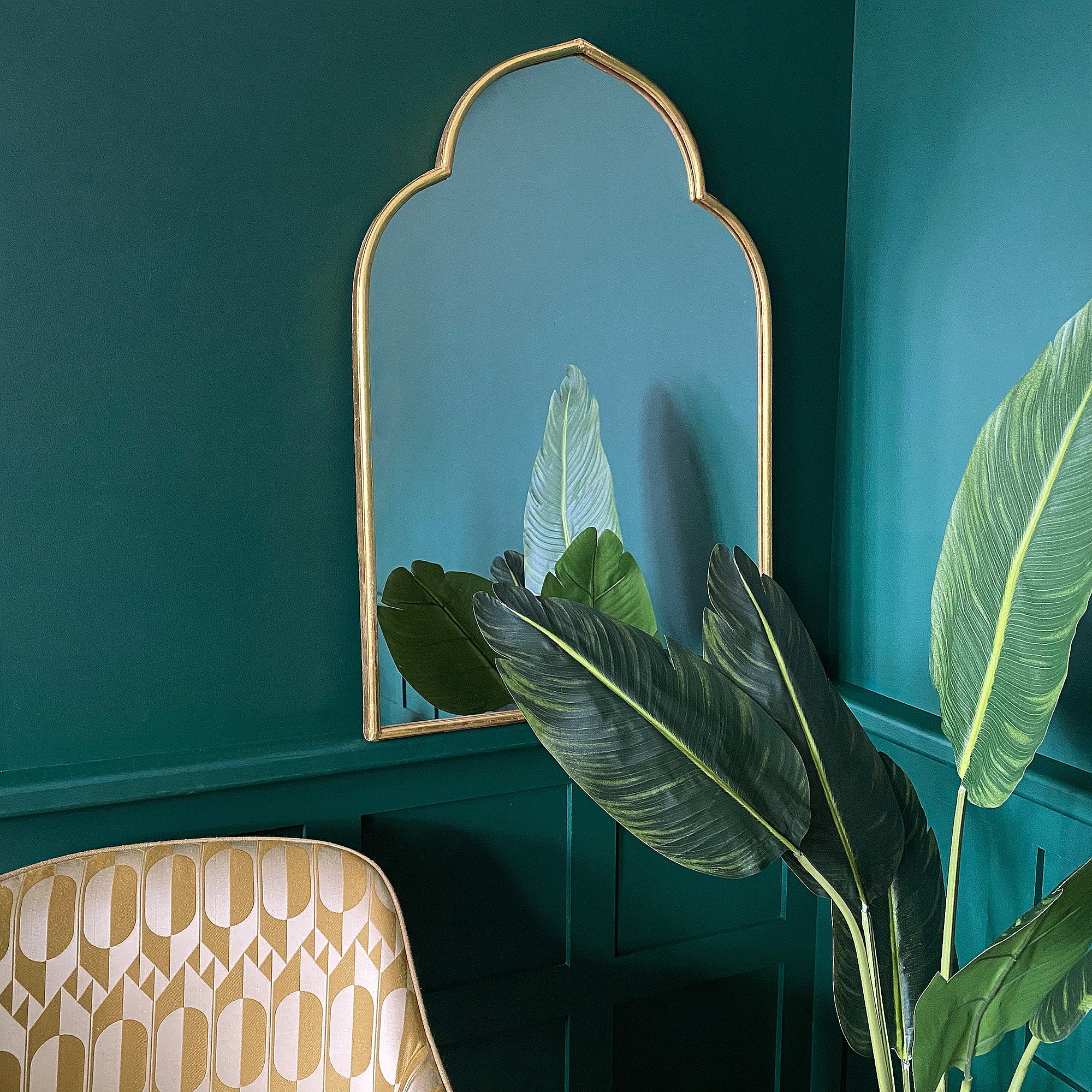 A gold Moroccan arch wall mirror